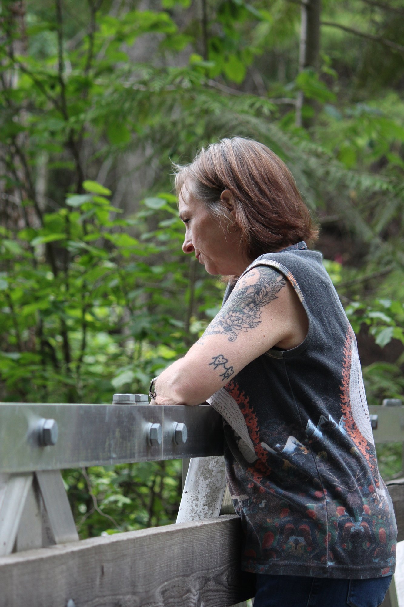 Jeunesse Pearson pausing on a bridge in a forest
